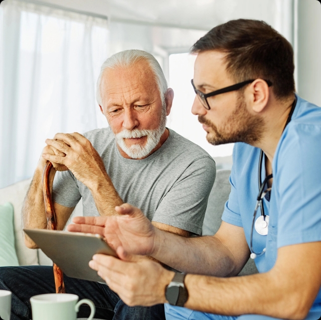 A healthcare worker assists a patient with a walker.